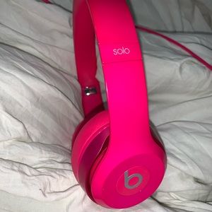 Hot pink Beats headphones